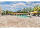 Community pool featuring a zero entry, a covering, and surrounded by a brick deck at 3876 Crossline Dr, Spring Hill, FL 34609