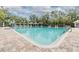 Community pool featuring a lap lane, and lounge chairs under a pergola at 3876 Crossline Dr, Spring Hill, FL 34609