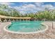 Community pool featuring a zero entry, a covering, and an abundance of lounge chairs at 3876 Crossline Dr, Spring Hill, FL 34609