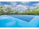 Community tennis courts featuring blue surfacing, new nets, and lights for night play at 3876 Crossline Dr, Spring Hill, FL 34609