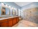 Bathroom boasting a double sink vanity and glass-enclosed walk-in shower at 445 Noble Faire Dr, Sun City Center, FL 33573