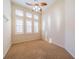 Carpeted bedroom with ceiling fan and multiple windows with natural light at 445 Noble Faire Dr, Sun City Center, FL 33573