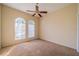 Bedroom with ceiling fan and natural light from two arched windows at 445 Noble Faire Dr, Sun City Center, FL 33573