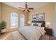 Serene bedroom with arched windows, neutral tones, and coordinated decor at 445 Noble Faire Dr, Sun City Center, FL 33573