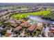 Aerial view of golf course community with luxurious clubhouse amenities, including a pool and golf course at 445 Noble Faire Dr, Sun City Center, FL 33573