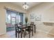 Dining area with a view of the patio, art, and a chandelier at 445 Noble Faire Dr, Sun City Center, FL 33573