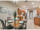 Bright dining area with seating for four and an adjacent kitchen at 445 Noble Faire Dr, Sun City Center, FL 33573