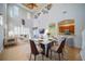 Open-concept dining area with a marble table, bar seating, and seamless flow to the kitchen at 445 Noble Faire Dr, Sun City Center, FL 33573