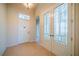 Inviting foyer with decorative glass doors and neutral tile flooring, creating a warm entrance at 445 Noble Faire Dr, Sun City Center, FL 33573