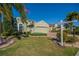 Beautifully landscaped home with a well-maintained lawn and garden at 445 Noble Faire Dr, Sun City Center, FL 33573