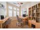 Inviting home office with natural light, built-in shelving, and a comfortable workspace at 445 Noble Faire Dr, Sun City Center, FL 33573