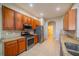 Galley kitchen with stainless steel appliances and wood cabinets at 445 Noble Faire Dr, Sun City Center, FL 33573