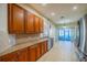 Spacious kitchen featuring granite countertops and stainless steel appliances at 445 Noble Faire Dr, Sun City Center, FL 33573