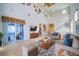 Spacious living room with high ceilings, decorative fish art, and a sliding door to a sunroom at 445 Noble Faire Dr, Sun City Center, FL 33573