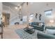 Comfortable living room with high ceilings, a staircase, and stylish decor at 445 Noble Faire Dr, Sun City Center, FL 33573