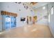 Bright living room with high ceilings, a wall-mounted TV, and sliding doors to the patio at 445 Noble Faire Dr, Sun City Center, FL 33573