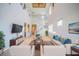 Bright living room with a staircase, high ceilings, decorative accents, and stylish furnishings at 445 Noble Faire Dr, Sun City Center, FL 33573