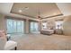 Staged main bedroom featuring a king bed, balcony access, and plenty of space at 445 Noble Faire Dr, Sun City Center, FL 33573