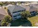 Back of the home featuring a screened-in porch and backyard at 445 Noble Faire Dr, Sun City Center, FL 33573
