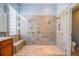 Glass enclosed walk-in shower features mosaic tile work and multiple shower heads at 445 Noble Faire Dr, Sun City Center, FL 33573