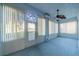Enclosed sunroom with light blue interior, plenty of windows and ceiling fan at 445 Noble Faire Dr, Sun City Center, FL 33573