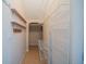Long and narrow walk-in closet with lots of shelving space for storage at 445 Noble Faire Dr, Sun City Center, FL 33573