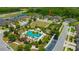 Aerial view of a home, community pool, and green space in a beautiful neighborhood at 4551 Barletta Ct, Wesley Chapel, FL 33543