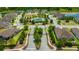 Beautiful aerial view of a Primary-planned community with a pool, clubhouse, and lush landscaping at 4551 Barletta Ct, Wesley Chapel, FL 33543