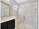 Modern walk-in shower with glass doors, seating, and a window in the bathroom at 4551 Barletta Ct, Wesley Chapel, FL 33543