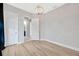 Bedroom boasting light hardwood flooring and neutral paint, plus a modern chandelier and closet doors at 4551 Barletta Ct, Wesley Chapel, FL 33543