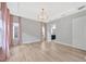 Bright bedroom with wood flooring and an elegant chandelier fixture at 4551 Barletta Ct, Wesley Chapel, FL 33543