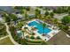 Aerial view of the community pool area featuring a pool, lounge chairs and landscaping at 4551 Barletta Ct, Wesley Chapel, FL 33543