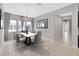 Elegant dining room with modern table set, neutral colors, and ample natural light at 4551 Barletta Ct, Wesley Chapel, FL 33543