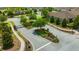 Gated community entrance featuring brick columns, lush landscaping, and well-maintained sidewalks at 4551 Barletta Ct, Wesley Chapel, FL 33543