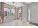 Bright foyer featuring neutral tile floors, a decorative chandelier, and pink accents at 4551 Barletta Ct, Wesley Chapel, FL 33543