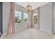 Bright foyer featuring neutral tile floors, a decorative chandelier, and pink accents at 4551 Barletta Ct, Wesley Chapel, FL 33543