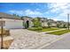 Charming single-Gathering home featuring a two-car garage, arched entryway, and beautifully landscaped front yard at 4551 Barletta Ct, Wesley Chapel, FL 33543