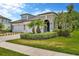 Beautiful home with manicured lawn, stone driveway and front entryway at 4551 Barletta Ct, Wesley Chapel, FL 33543