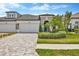 Charming two-story home with a well-manicured front yard, stone driveway and entryway at 4551 Barletta Ct, Wesley Chapel, FL 33543