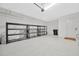 Spacious garage with epoxy flooring and shelving units for ample storage space at 4551 Barletta Ct, Wesley Chapel, FL 33543