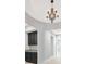 Hallway with dark cabinetry with granite countertops and an ornate chandelier that adds charm to the interior at 4551 Barletta Ct, Wesley Chapel, FL 33543