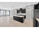 Spacious kitchen with an island and black cabinets, open to the living area and stainless steel appliances at 4551 Barletta Ct, Wesley Chapel, FL 33543