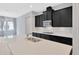 Bright kitchen featuring a large island, stainless steel appliances, and dark cabinetry at 4551 Barletta Ct, Wesley Chapel, FL 33543