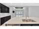 Open kitchen featuring a large island with a double sink and views to the outdoor patio at 4551 Barletta Ct, Wesley Chapel, FL 33543