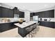 Stylish kitchen with dark cabinets, modern appliances, and a large island with bar stool seating at 4551 Barletta Ct, Wesley Chapel, FL 33543