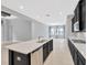 Open floor plan featuring kitchen island with stainless steel dishwasher at 4551 Barletta Ct, Wesley Chapel, FL 33543