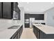 Spacious kitchen featuring dark cabinets, stainless steel appliances, and white quartz countertops at 4551 Barletta Ct, Wesley Chapel, FL 33543
