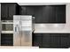 Kitchen featuring modern stainless steel refrigerator, built in microwave and oven, and dark wooden cabinets at 4551 Barletta Ct, Wesley Chapel, FL 33543