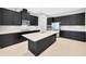 Contemporary kitchen with black cabinetry, stainless steel appliances, and a spacious white countertop island at 4551 Barletta Ct, Wesley Chapel, FL 33543