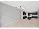 Open-concept space featuring dark cabinets, white countertops, and modern chandelier at 4551 Barletta Ct, Wesley Chapel, FL 33543